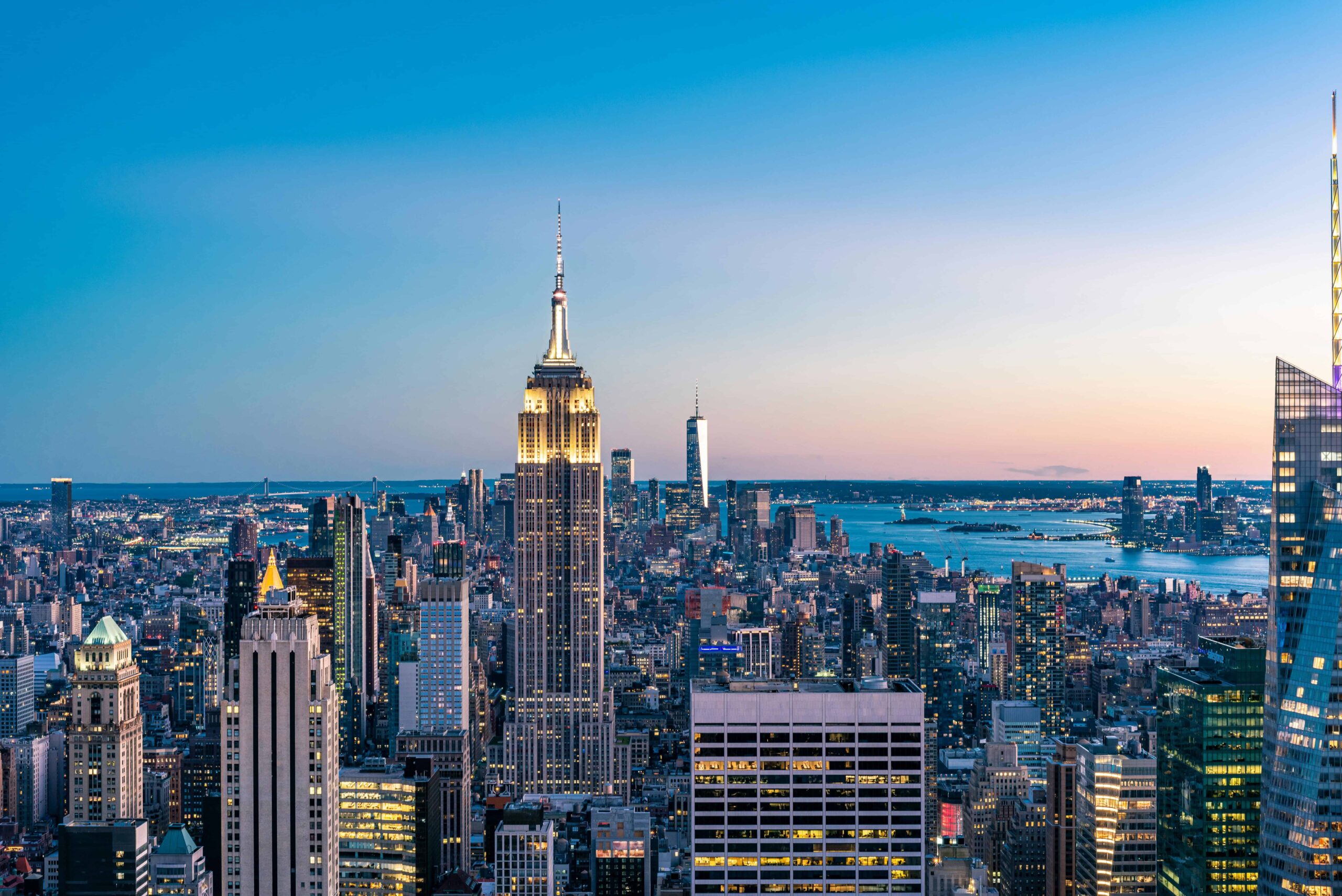 New York City skyline at sunset featuring the Empire State Building and surrounding skyscrapers
